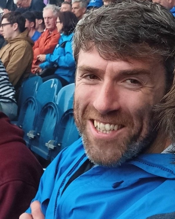 Kevin smiling at a sporting event
